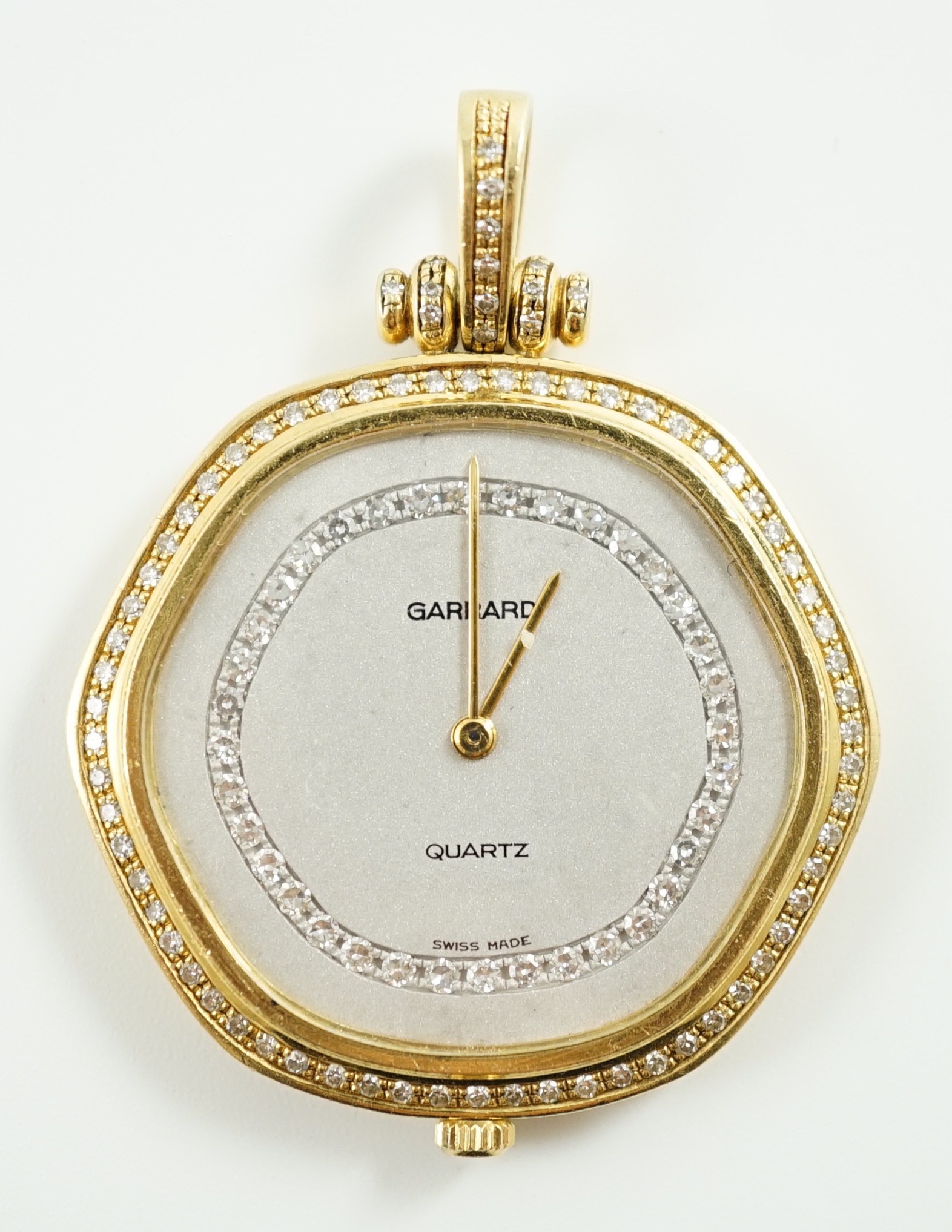 A modern 18ct gold and diamond set quartz shaped hexagonal pendant dress watch, retailed by Garrard